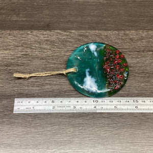 Fused Glass hanging disc with poppy field scene, with a ruler to demonstrate the entire length of the product, including the twine hanger.