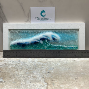 Fused Glass regular sized framed Light Aqua Crashing Wave design with a ruler to demonstrate the length of the piece.